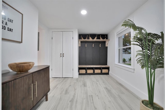 mudroom with light hardwood / wood-style flooring