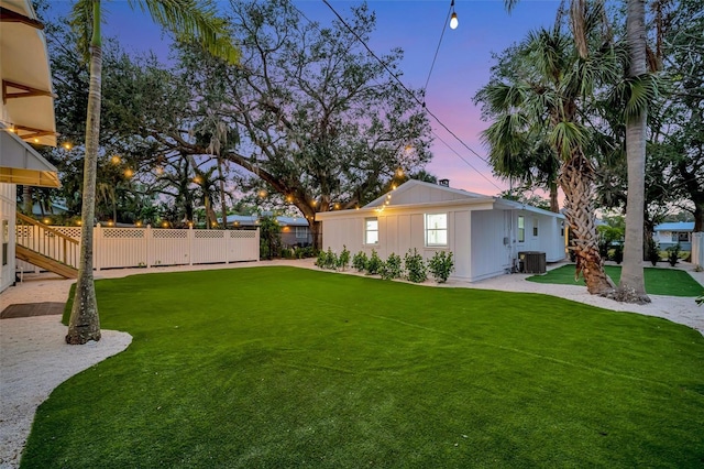 yard at dusk with central AC