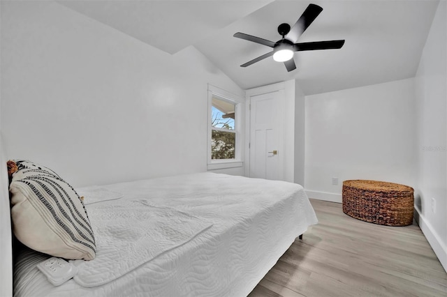 bedroom featuring lofted ceiling, ceiling fan, and light hardwood / wood-style floors