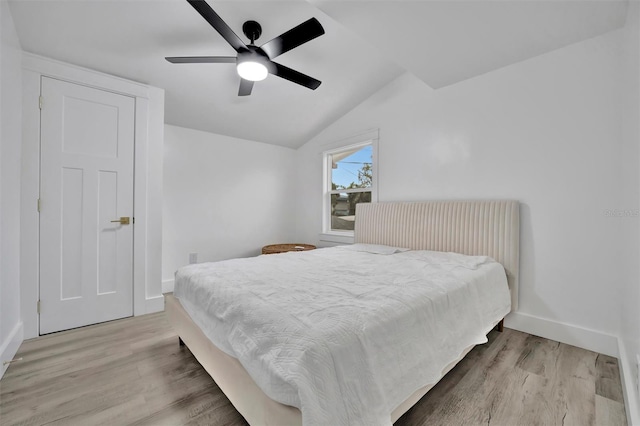 bedroom featuring lofted ceiling, ceiling fan, and light hardwood / wood-style flooring