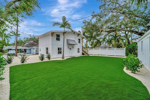 rear view of house with a yard