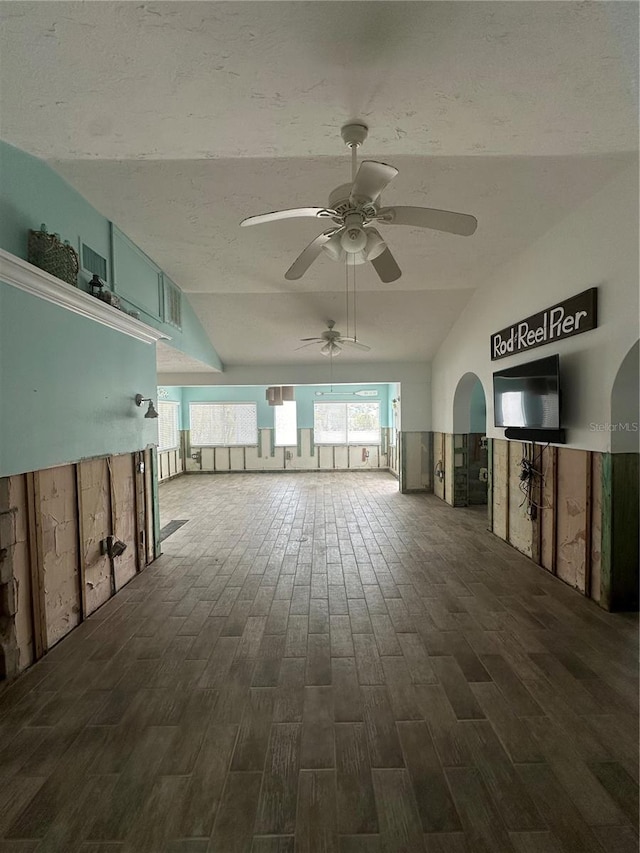 spare room featuring vaulted ceiling, ceiling fan, and dark wood-type flooring