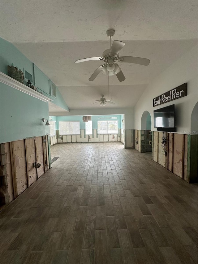 unfurnished room featuring ceiling fan, lofted ceiling, and dark hardwood / wood-style floors