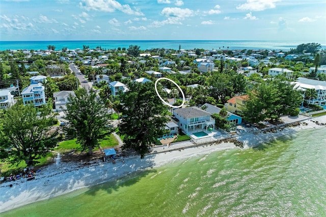 drone / aerial view featuring a beach view and a water view