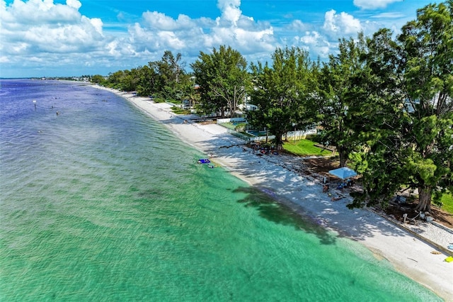 birds eye view of property with a view of the beach and a water view