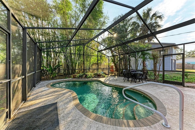 view of swimming pool featuring a lanai, a patio area, and a storage unit