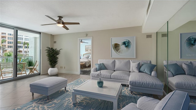 living room with a textured ceiling, light tile patterned floors, and a wall of windows