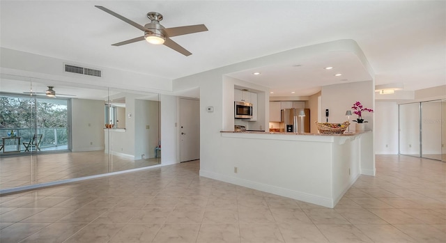 interior space featuring ceiling fan and light tile patterned floors