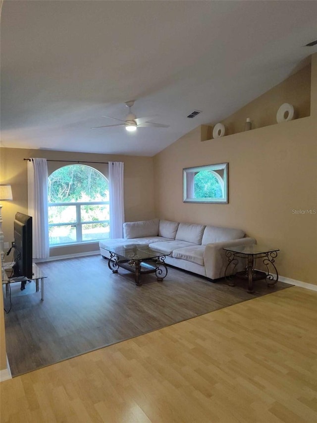 living room featuring ceiling fan, light hardwood / wood-style flooring, and lofted ceiling