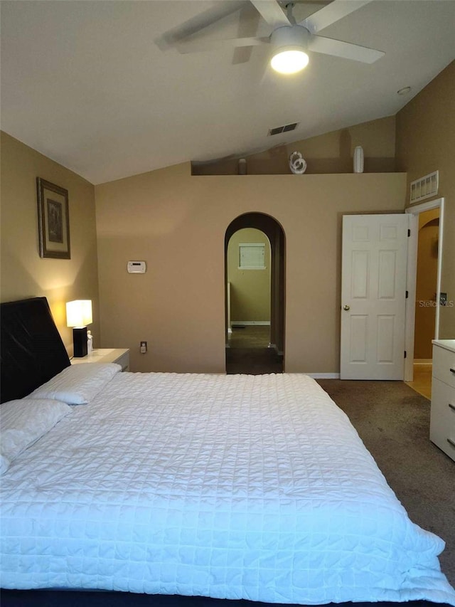 bedroom with ceiling fan, lofted ceiling, and dark colored carpet