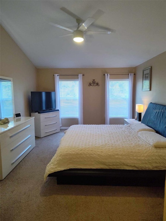 carpeted bedroom featuring vaulted ceiling and ceiling fan