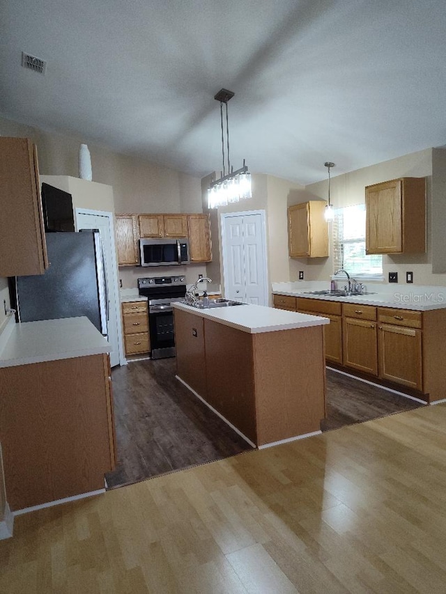 15900 SW 19th Avenue Rd, Ocala, FL 34473 - kitchen with appliances with stainless steel finishes, dark wood-type flooring, light countertops, vaulted ceiling, and a center island