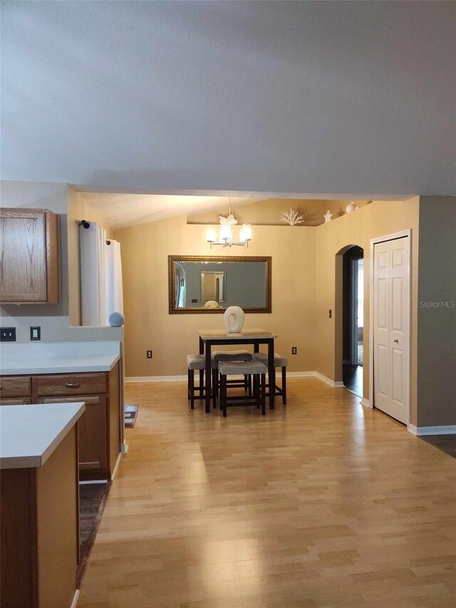 15900 SW 19th Avenue Rd, Ocala, FL 34473 - dining area with arched walkways, a chandelier, and light wood-style flooring