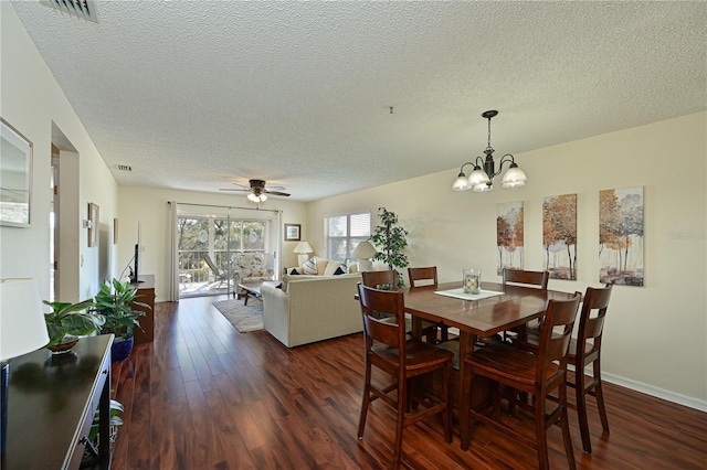 dining space featuring ceiling fan with notable chandelier, a textured ceiling, and dark hardwood / wood-style flooring