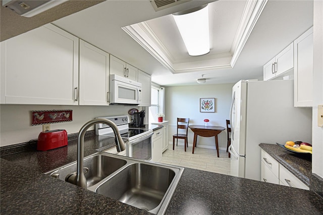 kitchen featuring white cabinetry, sink, ornamental molding, a raised ceiling, and white appliances