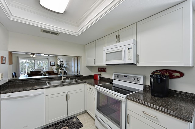 kitchen featuring sink, white appliances, a tray ceiling, ornamental molding, and white cabinets