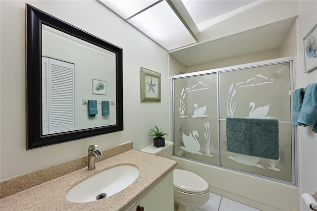 full bathroom featuring vanity, shower / bath combination with glass door, and toilet