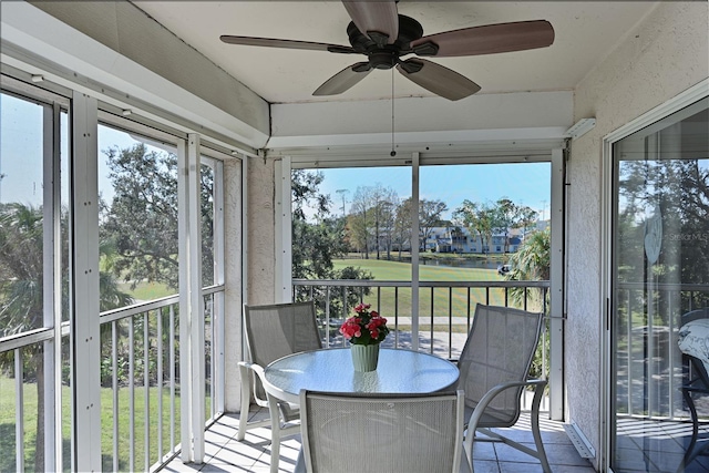 sunroom / solarium featuring ceiling fan