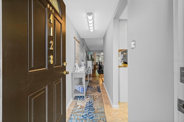 corridor featuring light tile patterned floors