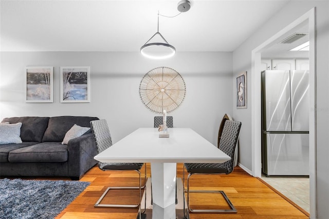 dining area with hardwood / wood-style floors