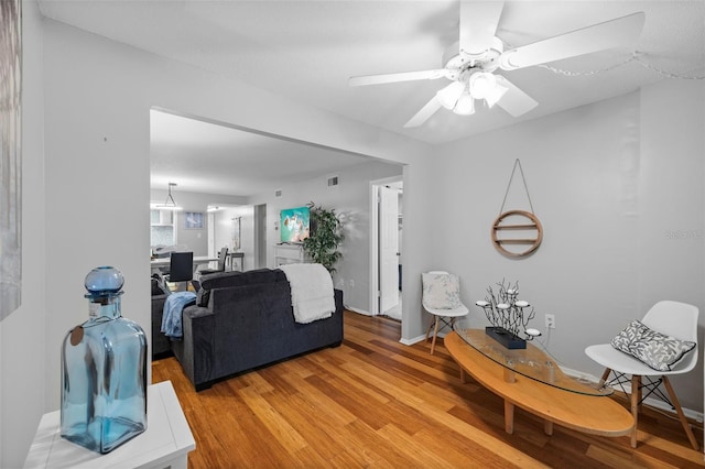 living room featuring ceiling fan and light hardwood / wood-style flooring