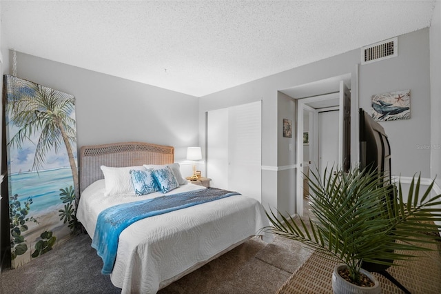 bedroom with a textured ceiling and carpet