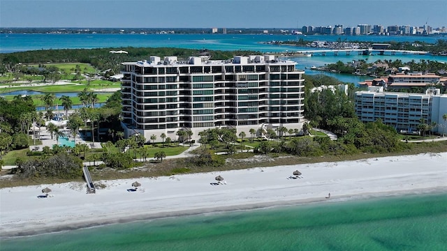 bird's eye view with a water view and a beach view