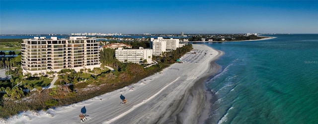 drone / aerial view featuring a beach view and a water view