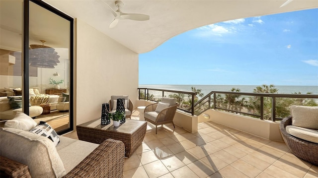 balcony featuring a water view, ceiling fan, and a view of the beach