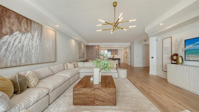 living room with a chandelier and light hardwood / wood-style flooring