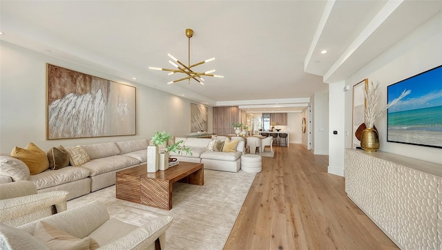 living room with light hardwood / wood-style flooring and a notable chandelier