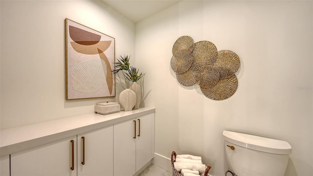 bathroom with toilet and tile patterned floors