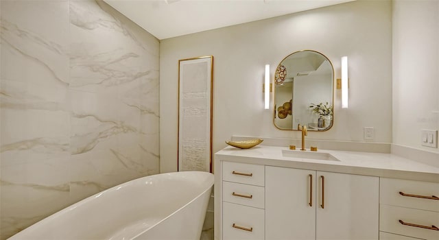 bathroom with vanity and a washtub