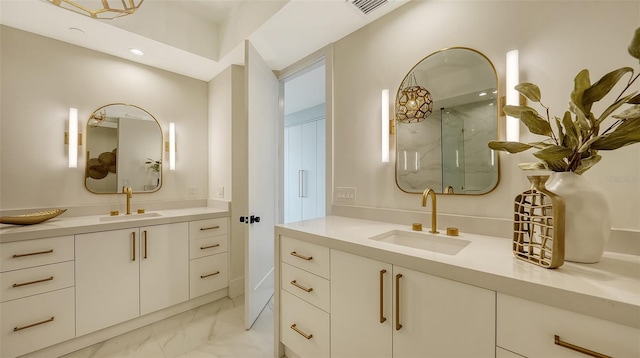 bathroom with a shower with shower door and vanity