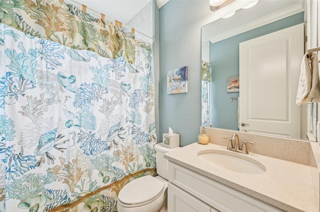 bathroom featuring toilet, vanity, ornamental molding, and a shower with curtain