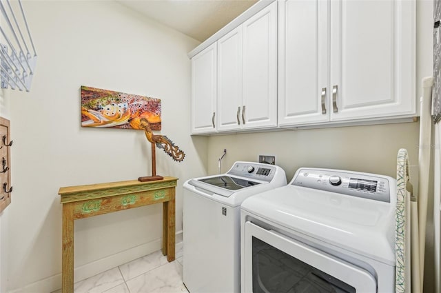 washroom featuring independent washer and dryer and cabinets