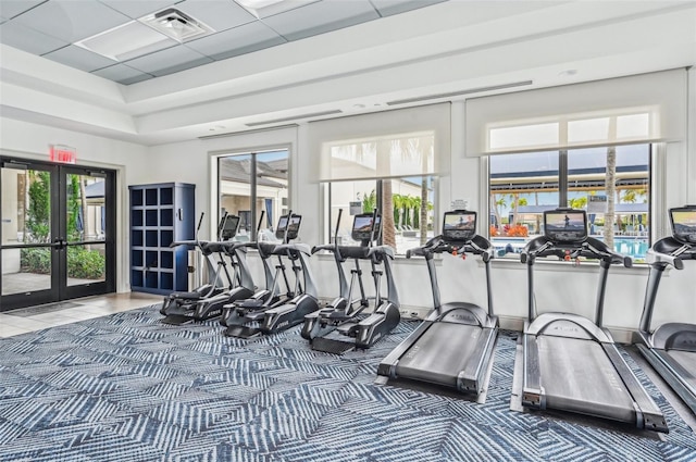 workout area featuring french doors and a drop ceiling