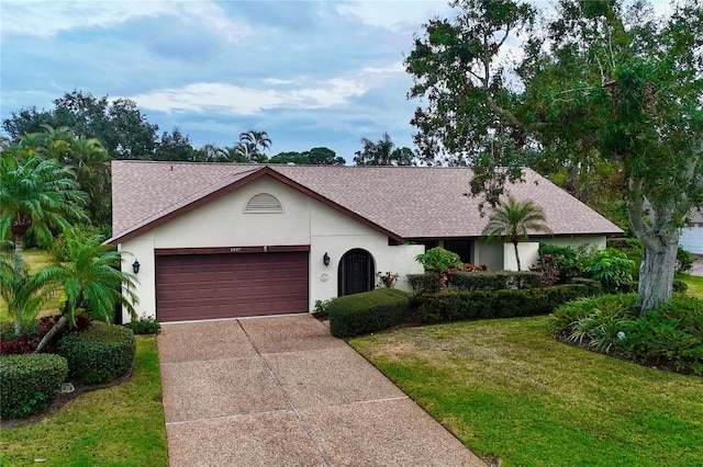 ranch-style home with a front lawn and a garage