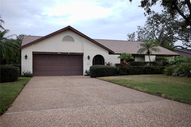 ranch-style house featuring a garage and a front yard