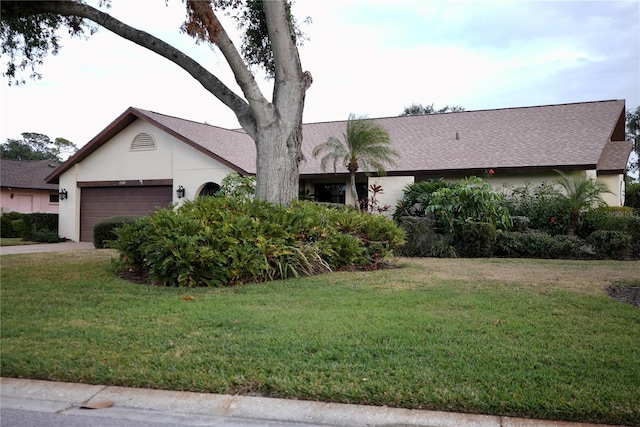 ranch-style house with a front yard and a garage