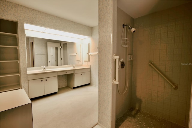 bathroom with vanity and a tile shower