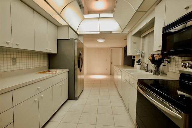 kitchen with sink, white cabinets, and stainless steel appliances