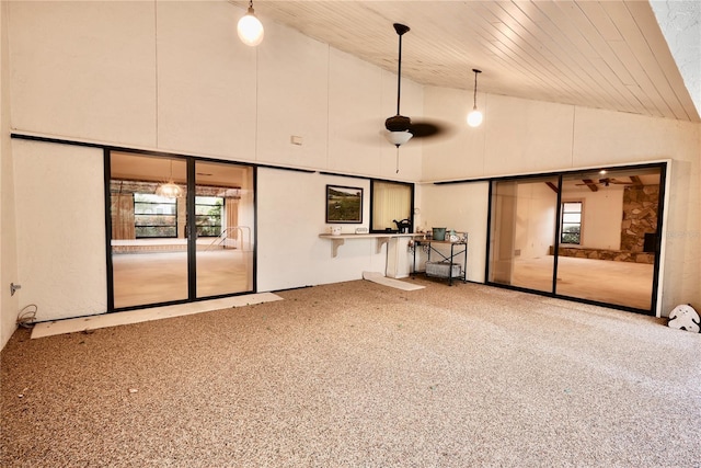 interior space with wooden ceiling, carpet floors, and high vaulted ceiling