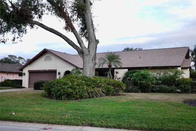 ranch-style home with a front lawn and a garage