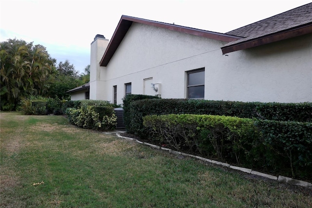 view of property exterior with a lawn