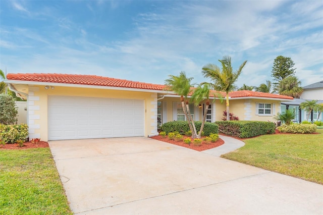 single story home with a garage and a front lawn