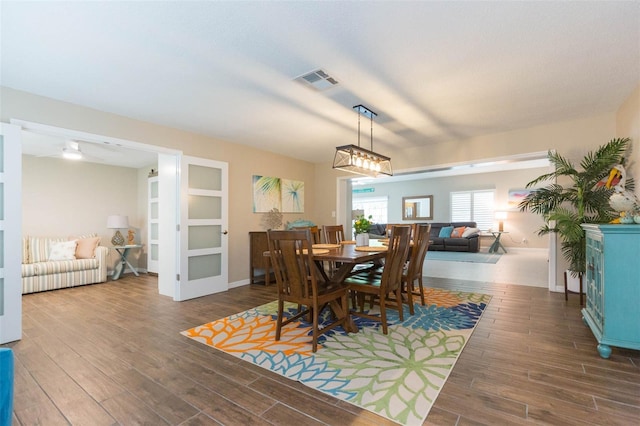 dining space with dark hardwood / wood-style floors