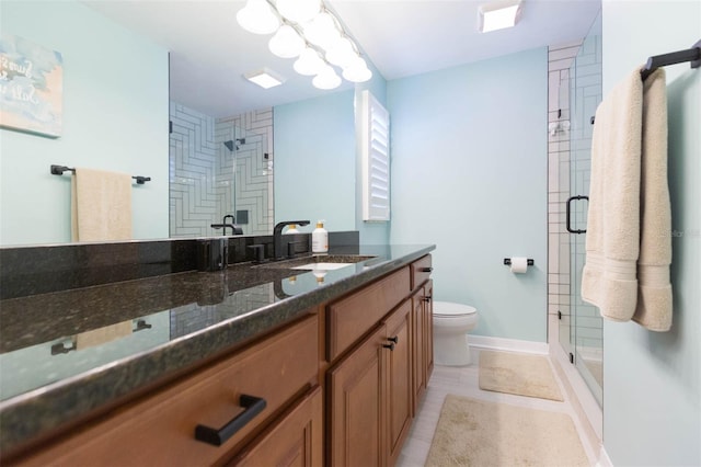 bathroom featuring vanity, tile patterned floors, a shower with door, and toilet