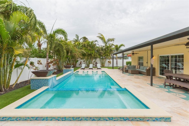 view of swimming pool with outdoor lounge area, a patio, and ceiling fan