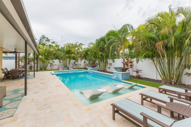 view of pool with ceiling fan and a patio area